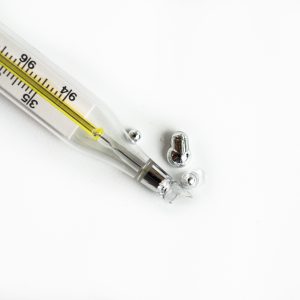 broken glass thermometer on white background