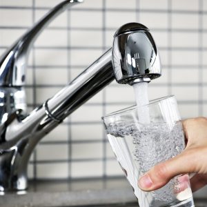 Filling glass of water from stainless steel kitchen faucet