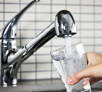 Filling glass of water from stainless steel kitchen faucet