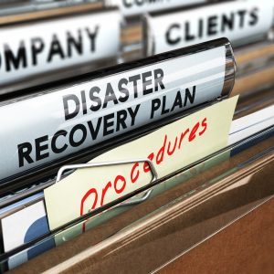 Close up on a file tab with the text Distaster Recovery Plan, focus on the main text and blur effect. Concept image for illustration of DRP ans crisis communication.