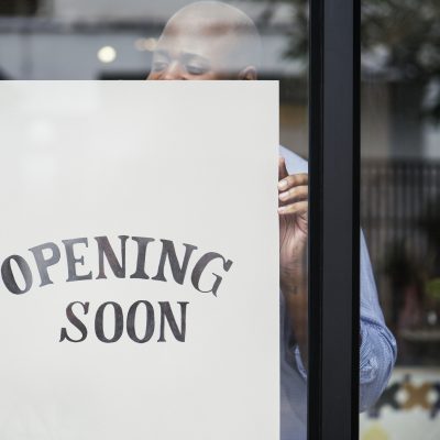 Man putting on store opening soon sign Man putting on store opening soon sign ***These are our own 3D generic designs. They do not infringe on any copyrighted designs.***